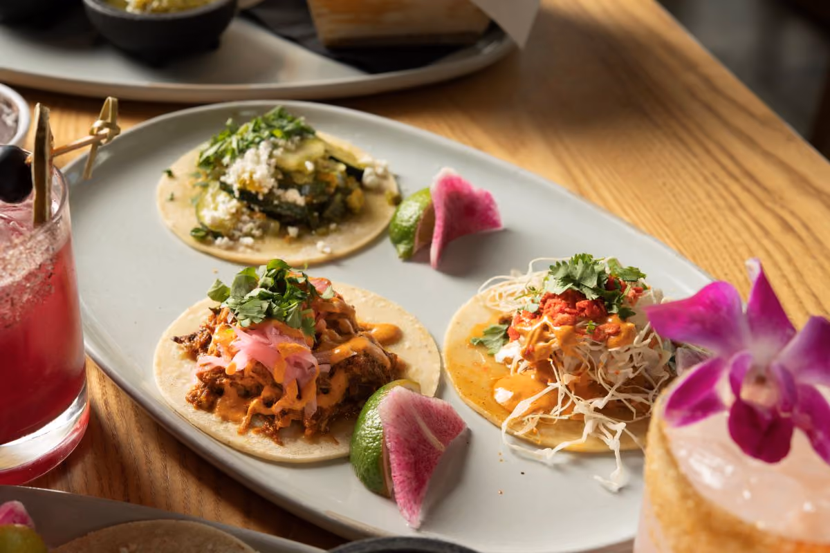 three tacos and sides of Salsa and crema