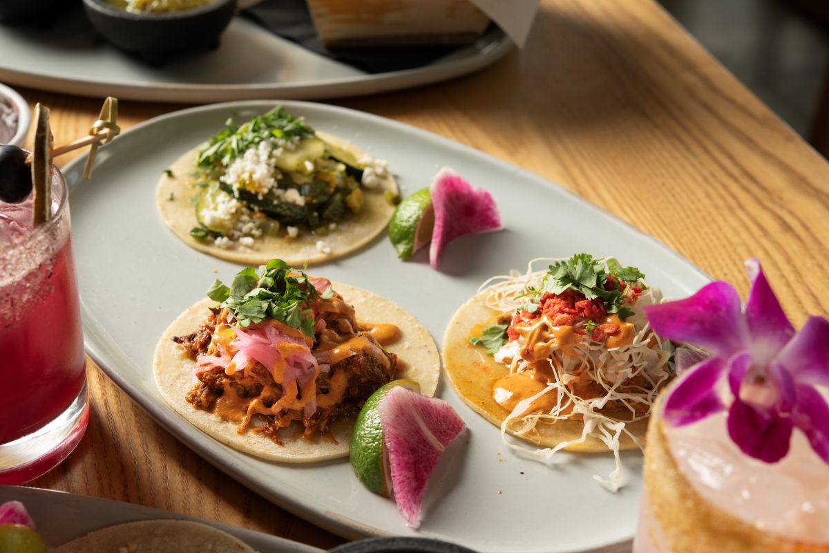 three tacos and sides of Salsa and crema