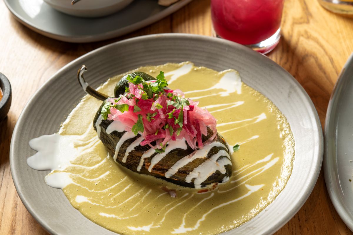 Shrimp stuffed Poblano pepper with pickled red onion on bed of green crema sauce