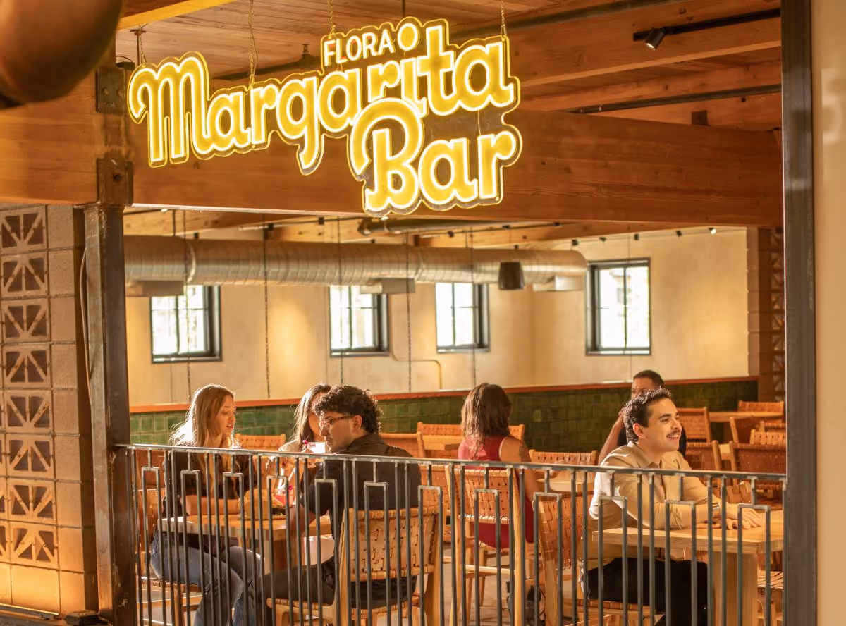 Long distance photo of group of people sitting in Margarita Bar, Neon Flora Margarita Bar photo.