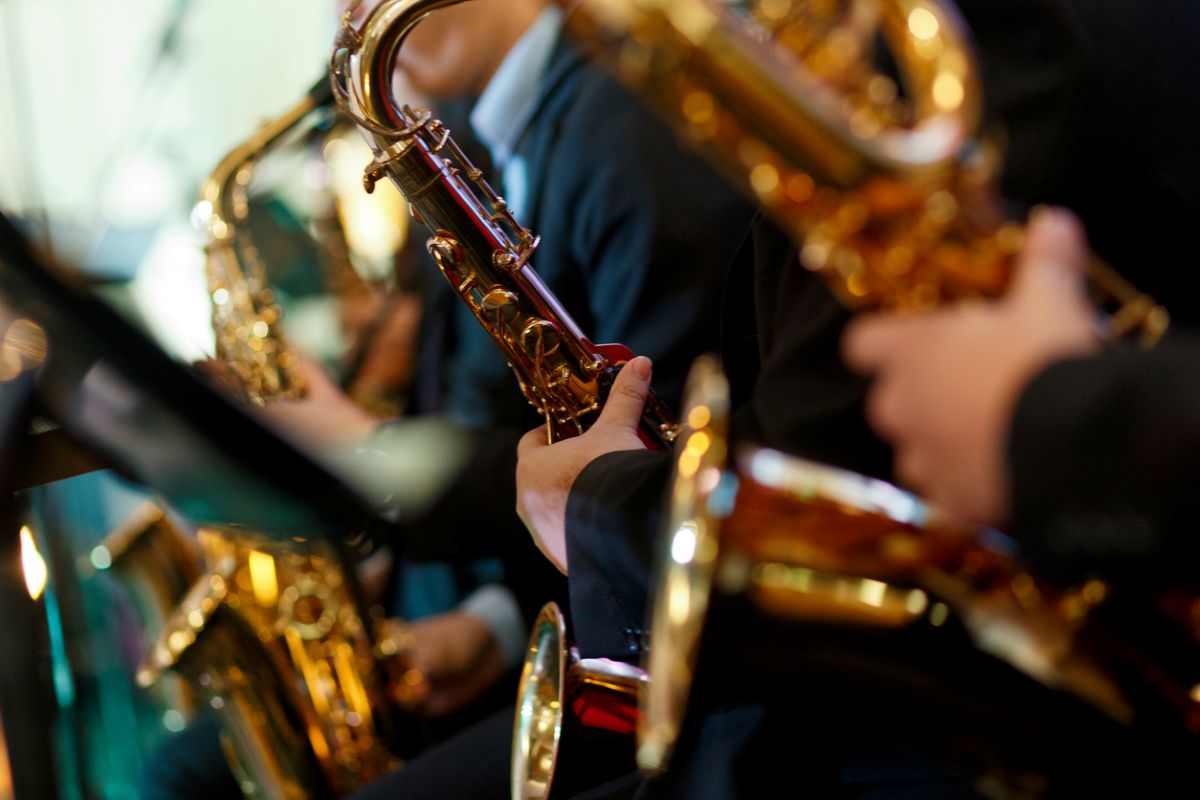 Row of Saxaphones being played in an ensemble
