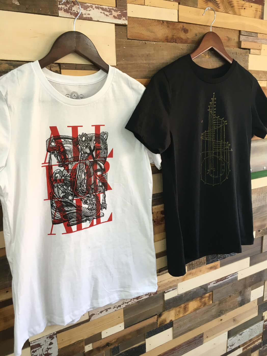 Printed white and black t-shirts, hanging up