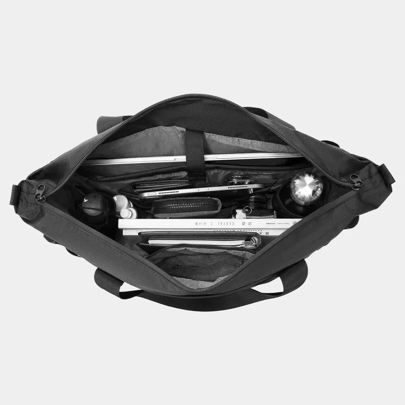 Top down view of a black bag with stuff in it