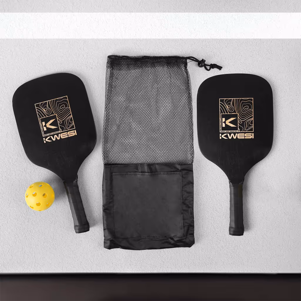 Two black pickleball paddles, a black bag, and a pickleball