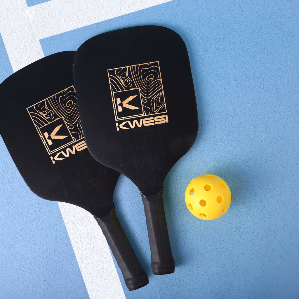 Two branded black pickleball paddles and a pickleball