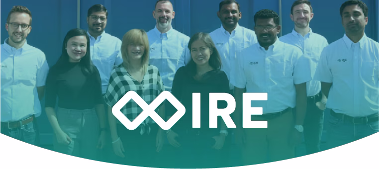 Group of diverse professionals standing together smiling with the IRE logo overlaid.