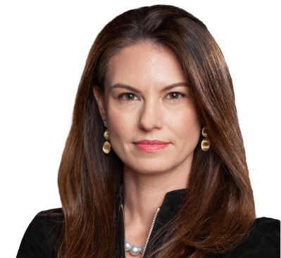 Photo of Rebecca; Photo of a young woman in a black, high neck, zippered dress/coat. She has short brown hair and brown eyes. She is wearing golden drop earrings and a white pearl necklace.