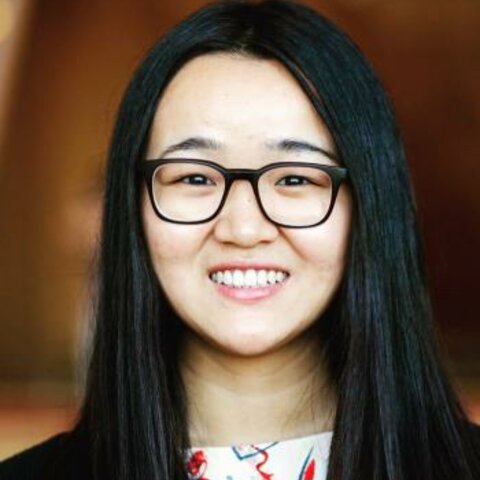 Photo of Diyi Yang; A headshot of a smiling young asian woman with long, straight black hair, wearing black-rimmed glasses and a patterned top.