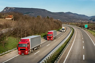 Semi trucks on a highway, representing VarTech Systems' HMI solutions for the transportation industry