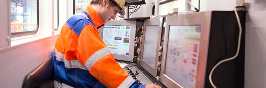 A worker operating a VarTech Systems HMI in an industrial facility
