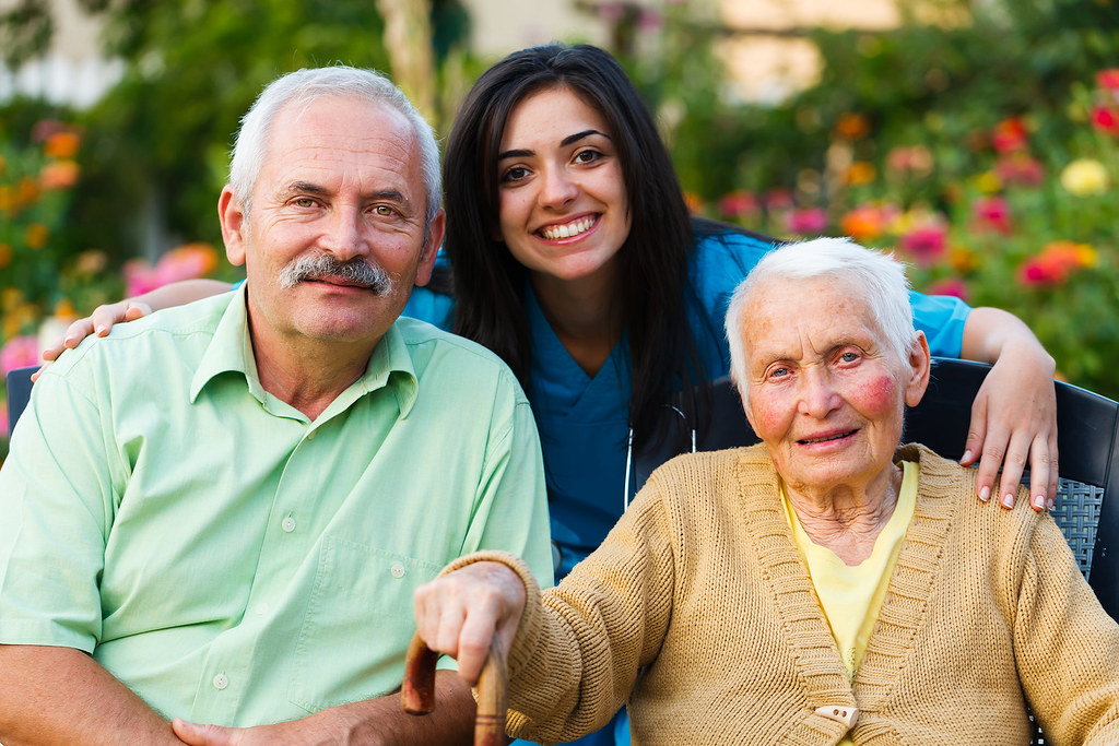 Family and home helper together in a garden