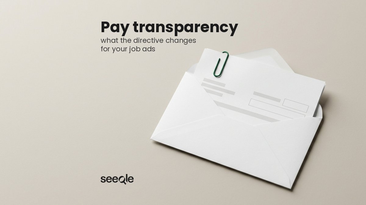 Open white salary envelope with a payslip and a green paper clip