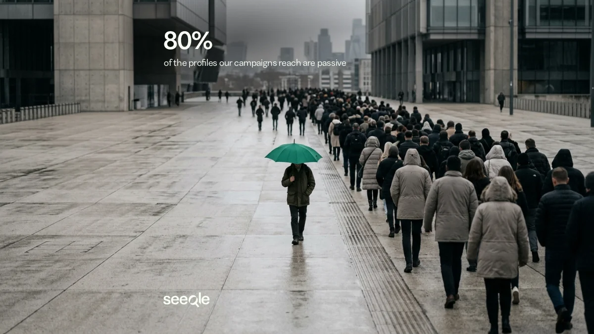 A person with a green umbrella walking against the crowd: 80% of the profiles our campaigns reach are passive