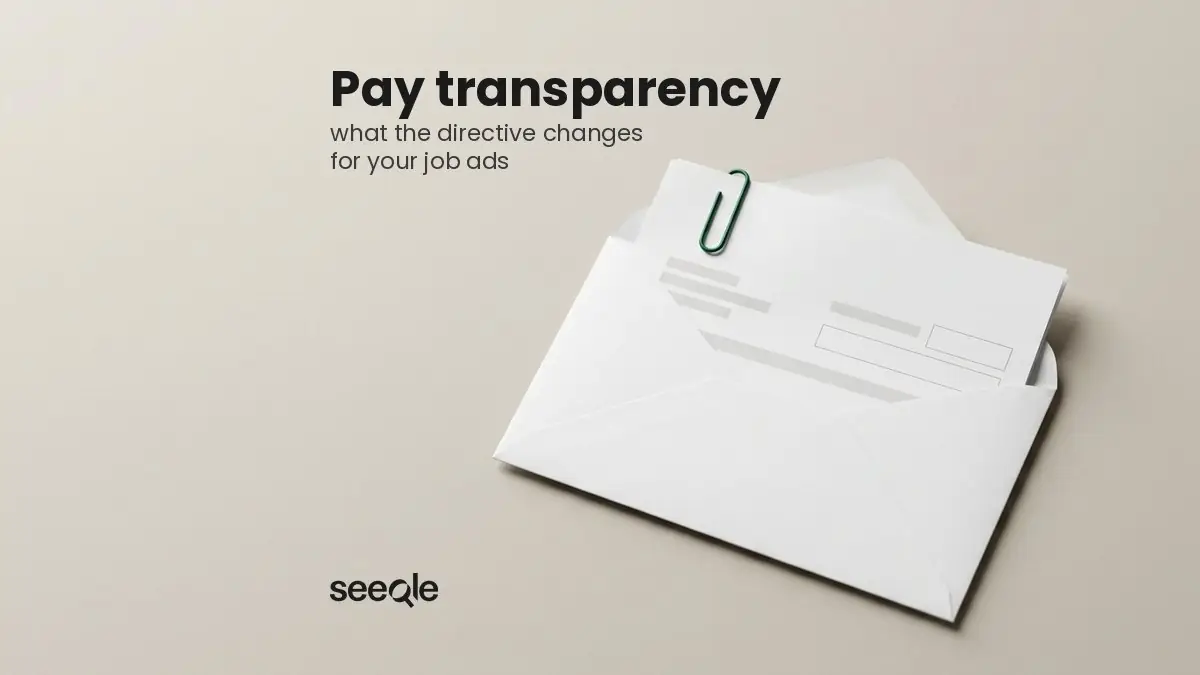 Open white salary envelope with a payslip and a green paper clip