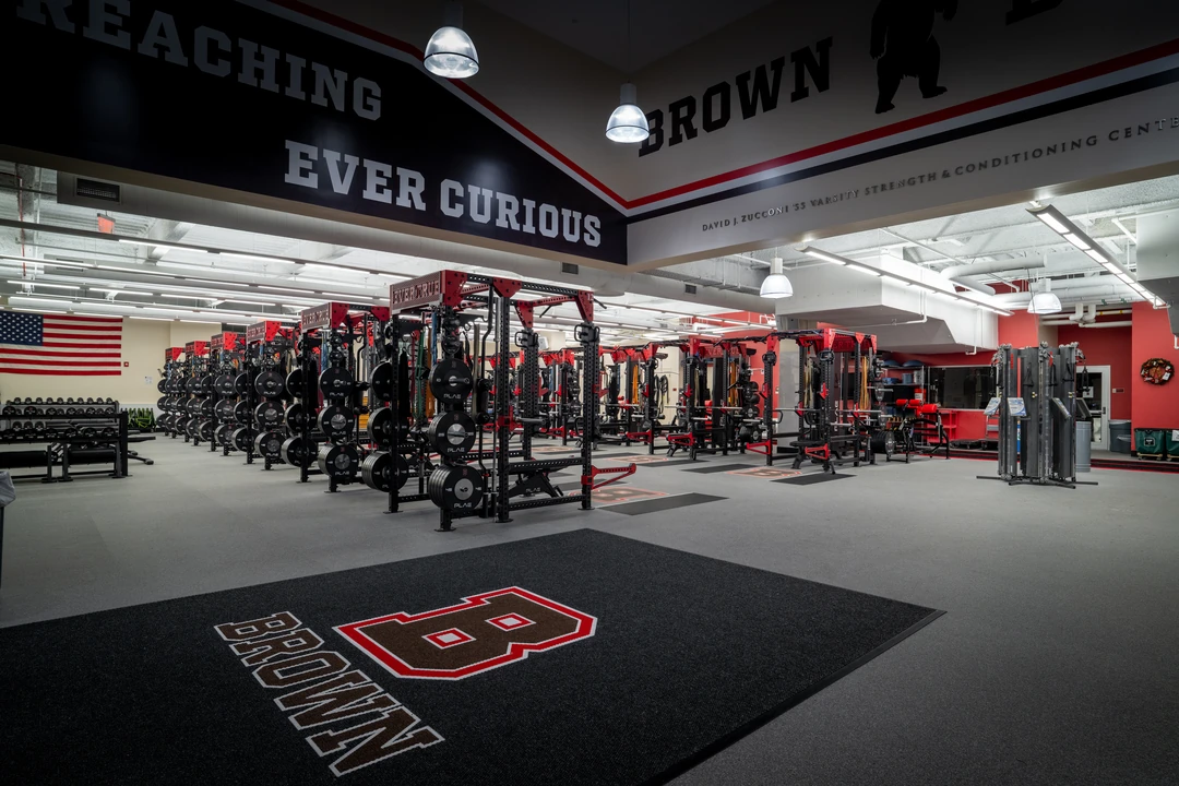 Wide entrance view of Brown University's performance facility featuring custom PLAE ICONx racks, custom entrance mat and collegiate branding.