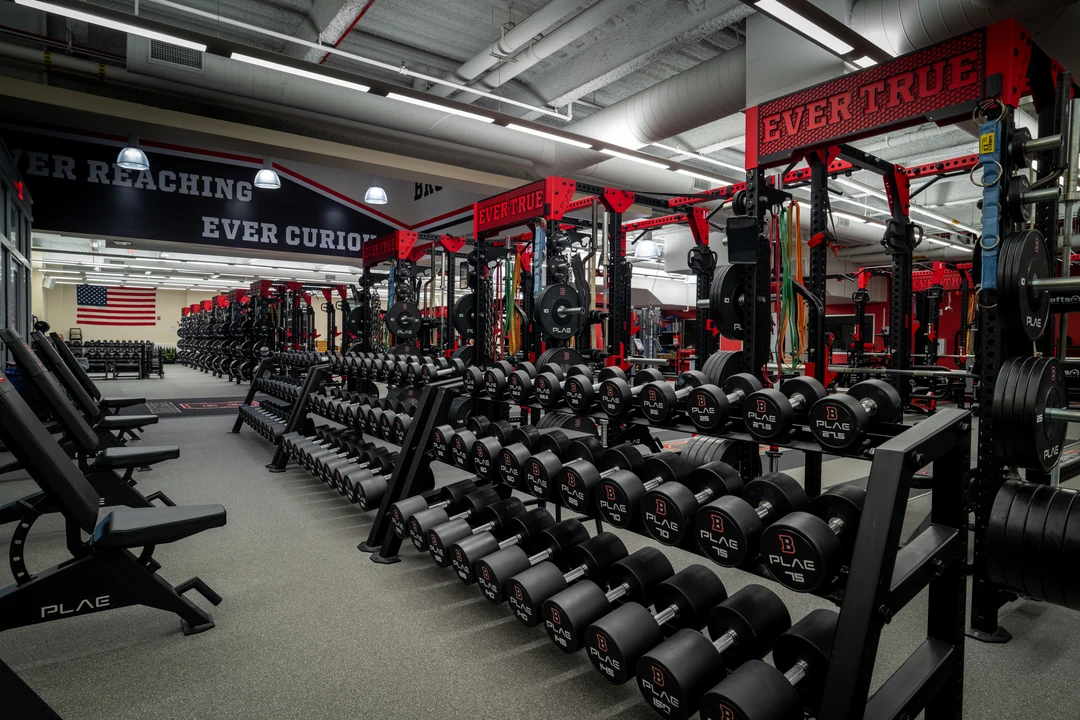 PLAE dumbbell storage and custom PLAE ICONx racks inside Brown University's collegiate strength training facility.