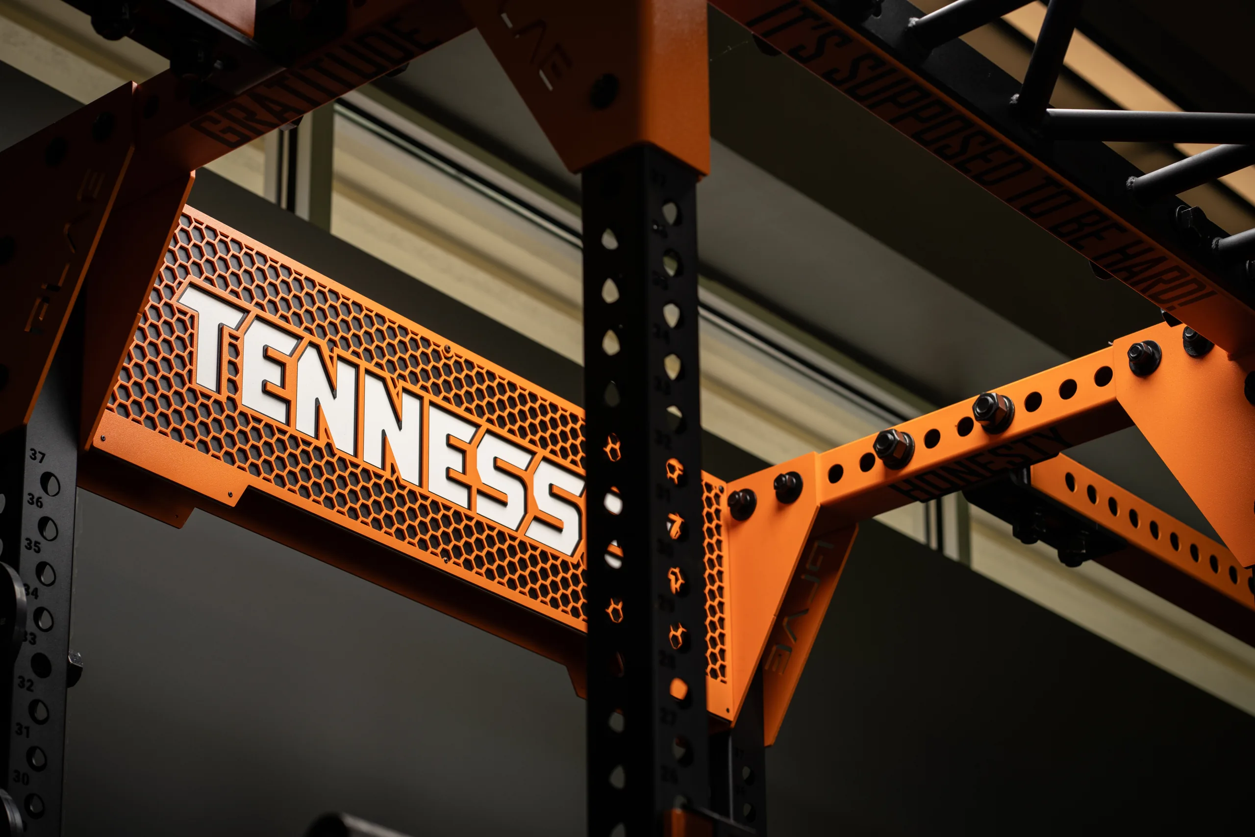 PLAE ICONx rack crossmember branded "Tennessee" with motivational uprights reading Gratitude, Honesty and "It's Supposed To Be Hard" in the Vols golf gym.