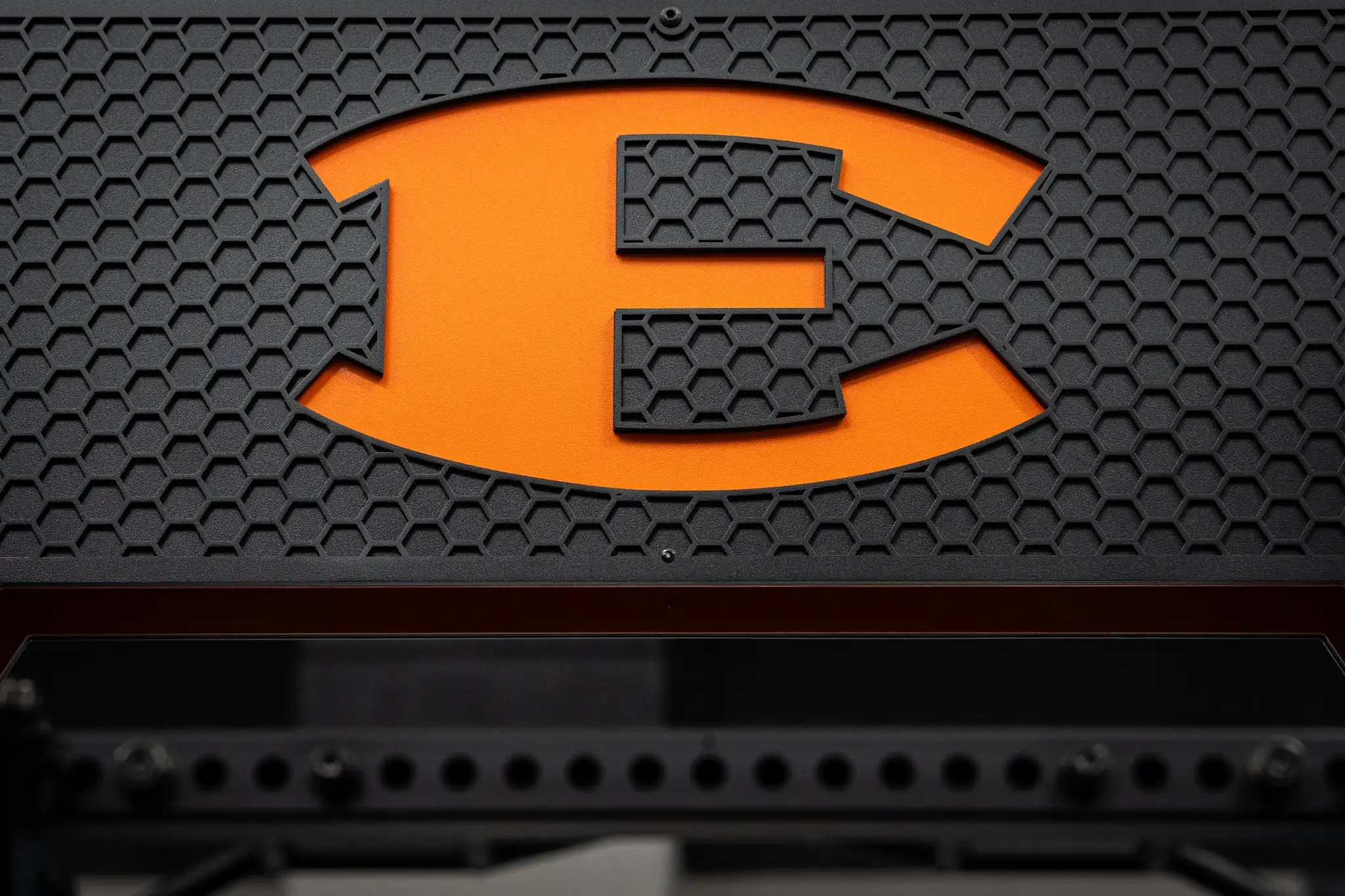 Detail of custom branded PLAE ICONx rack grille showcasing bespoke branding and premium steel fabrication.