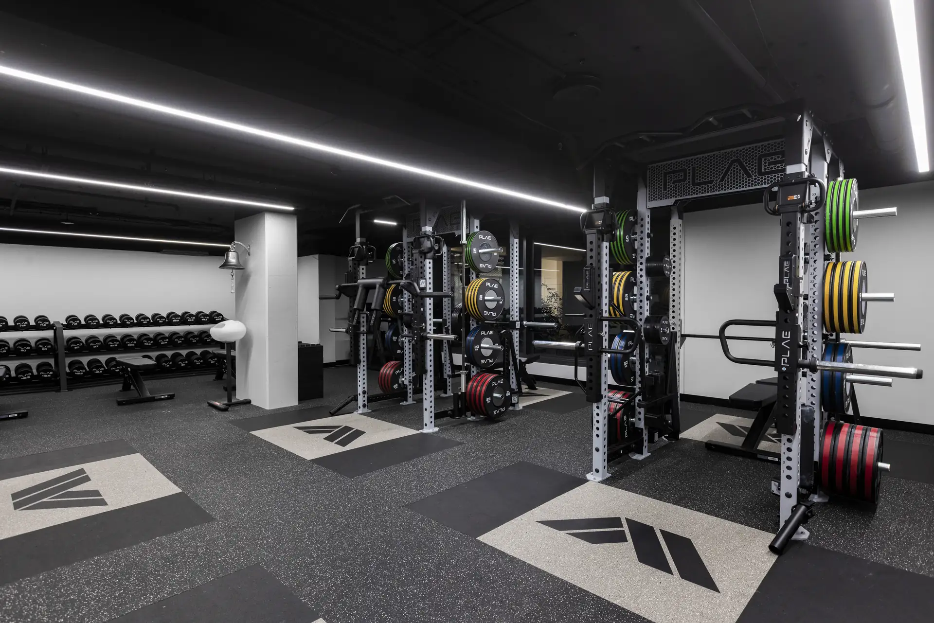 Row of ICONx racks with custom PLAE platforms under linear lighting at Athletes Authority Sydney