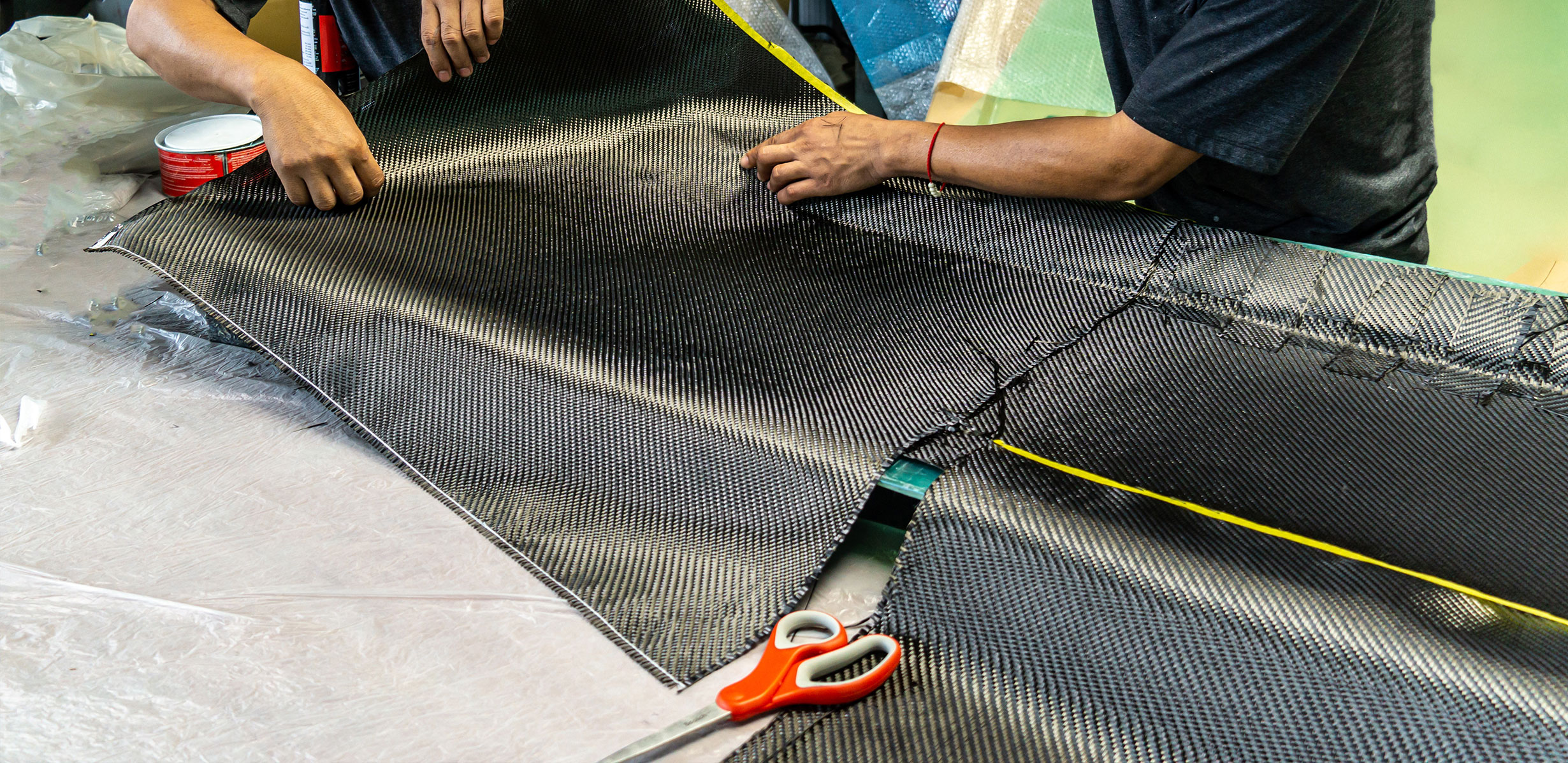 Workers laying up carbon fiber