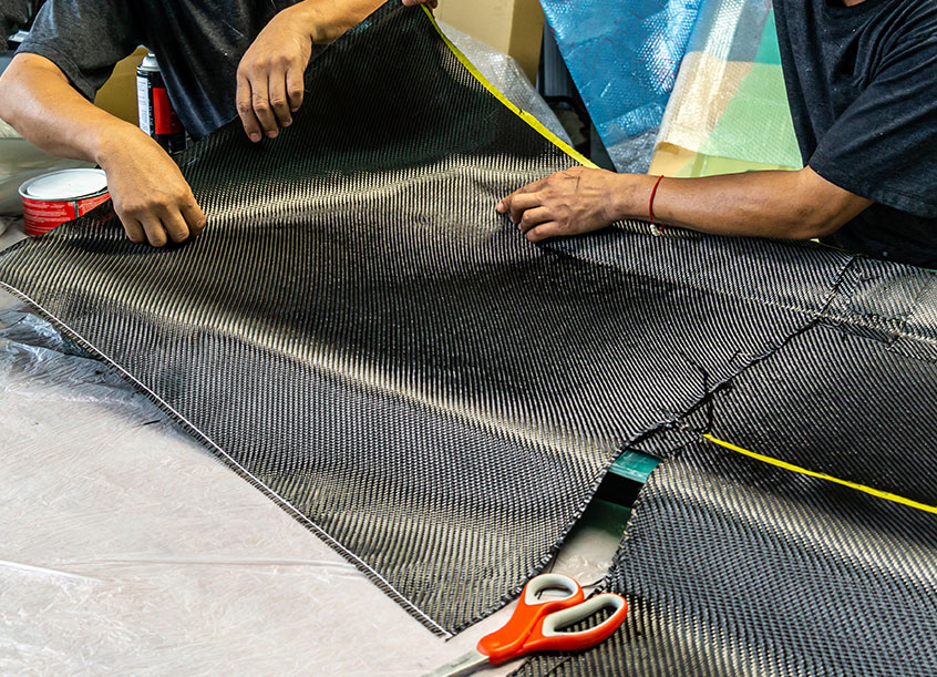 Workers laying up carbon fiber