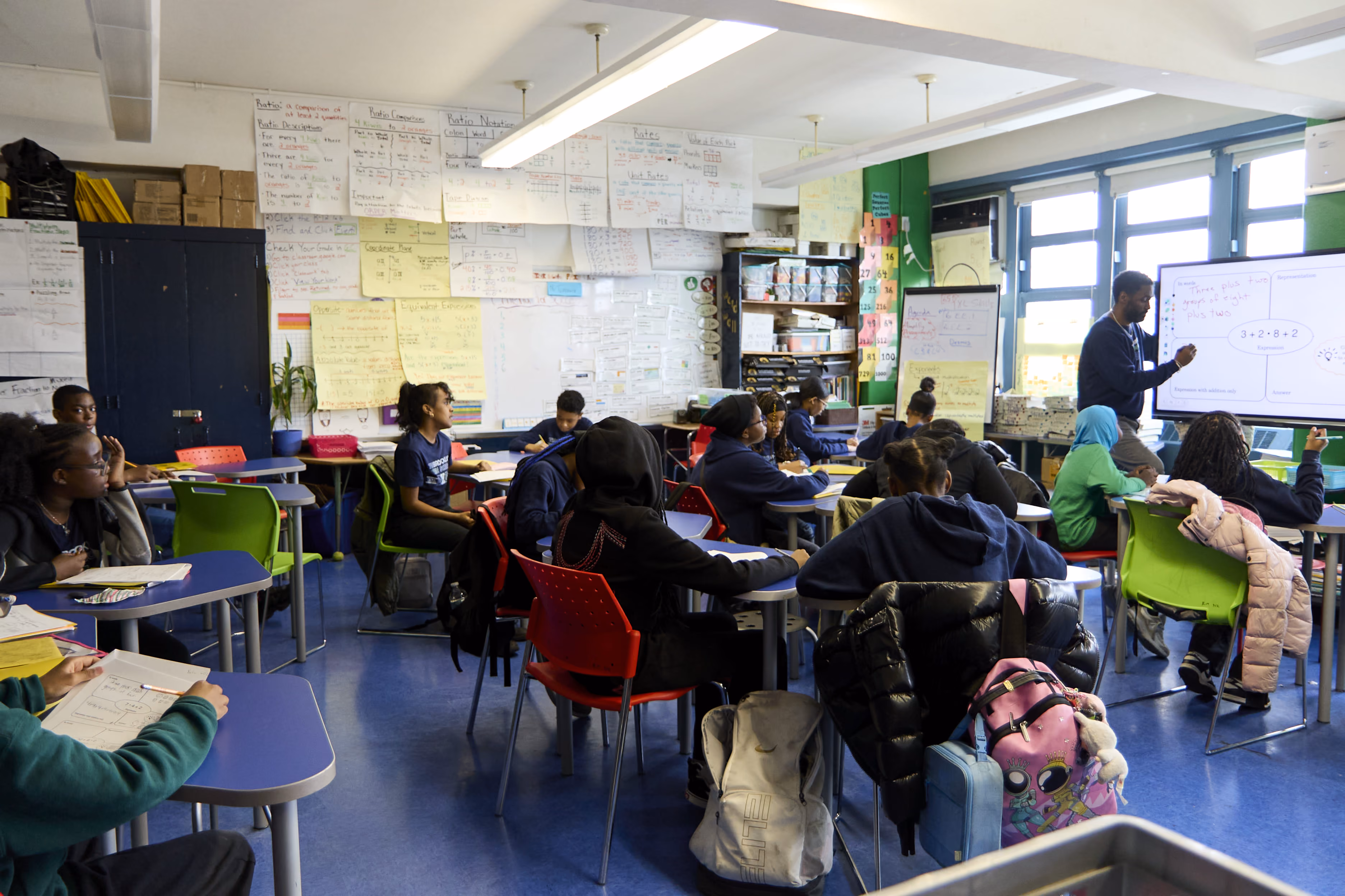 Teacher leads a math lesson for middle school students in classroom