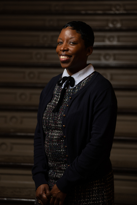 Fabayo McIntosh smiling in professional attire at district office