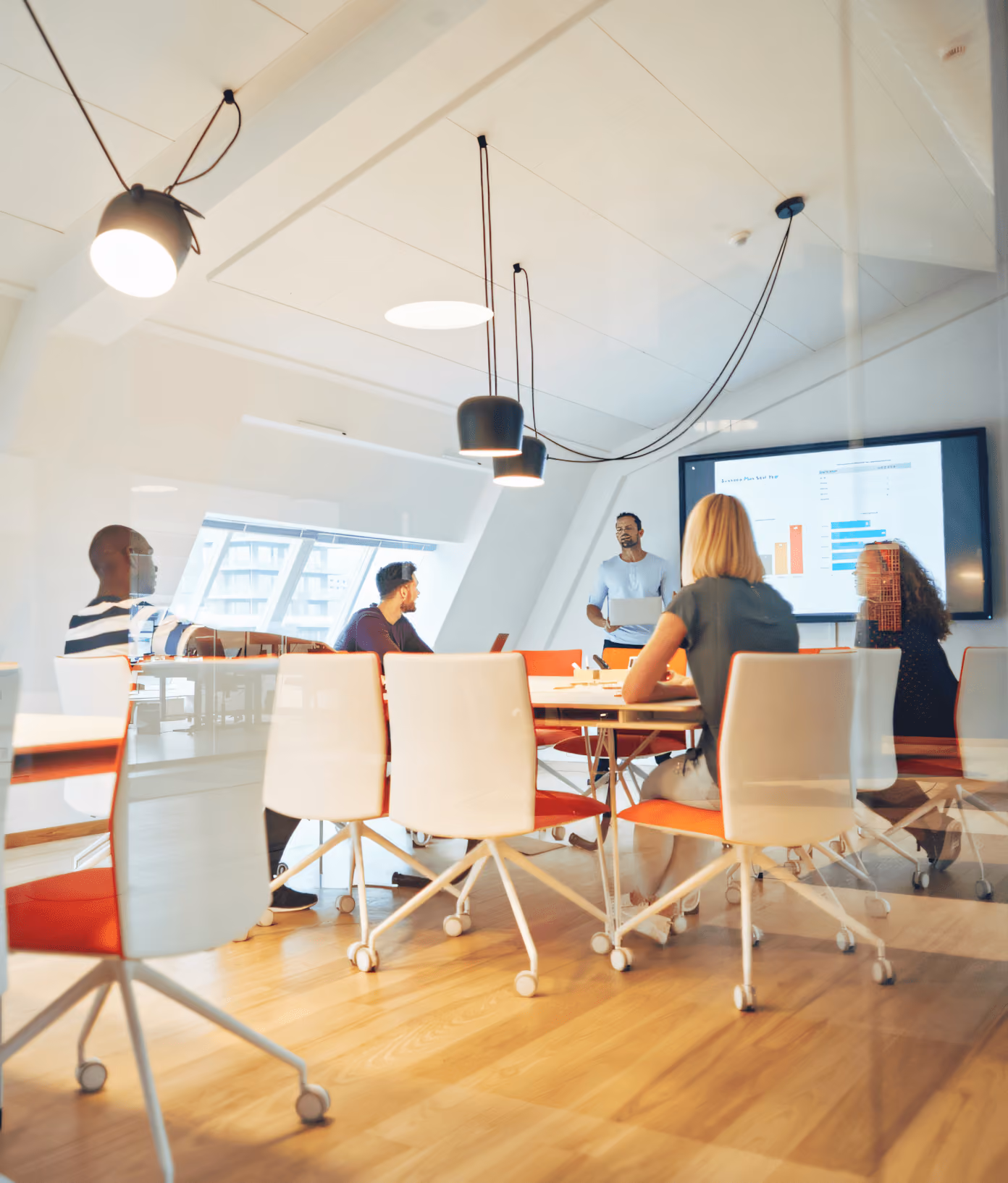 Team meeting in modern office conference room with presentation on screen