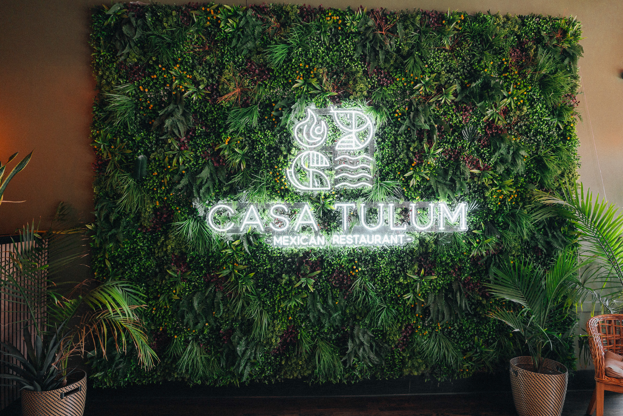 Casa Tulum neon sign on living green wall