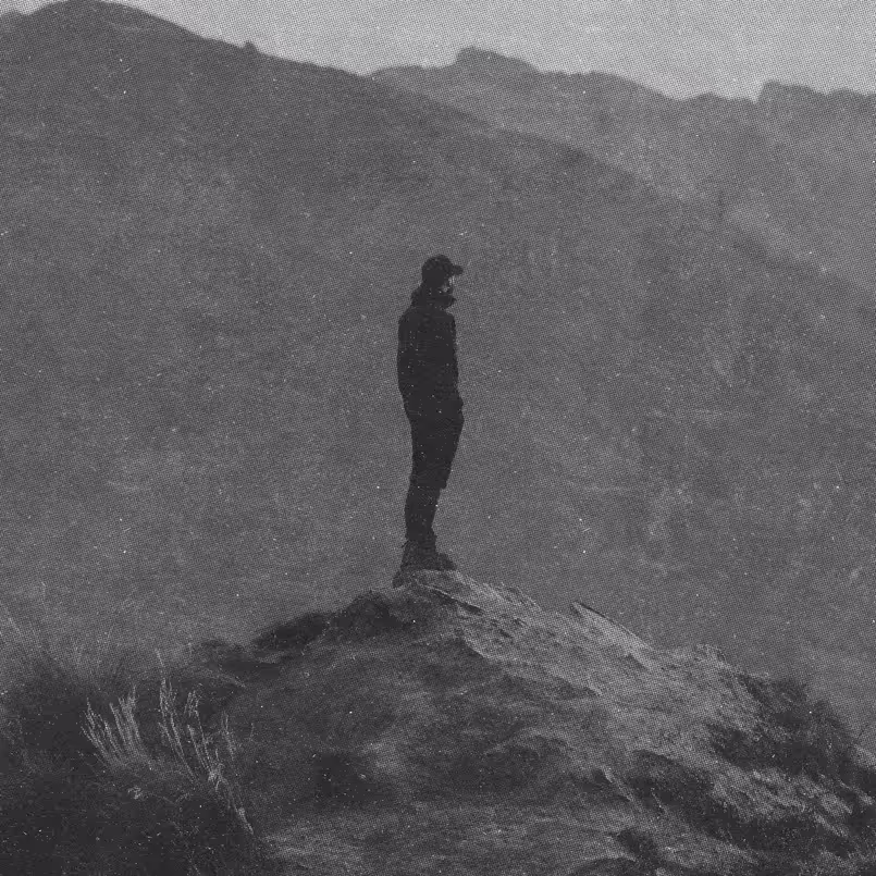 a man standing on a rock in the wilderness