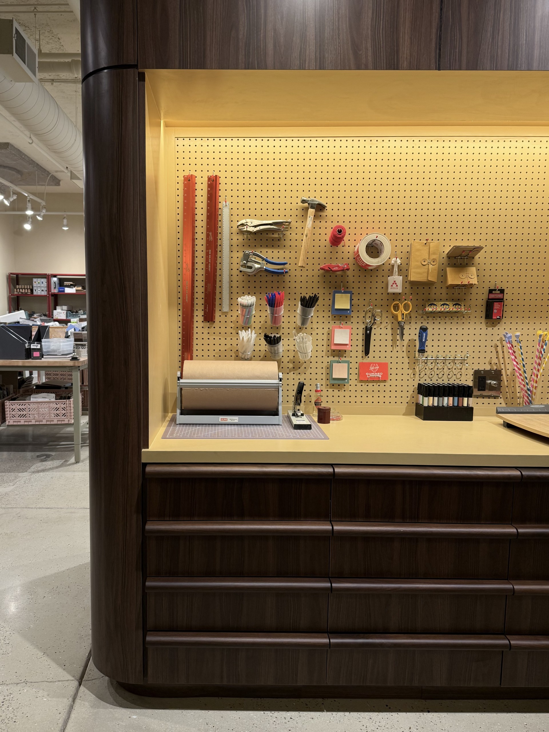 A stylish, modern office with wood-paneled walls, sleek furniture, and a patterned yellow and black rug in Avenir Creative's workspace.