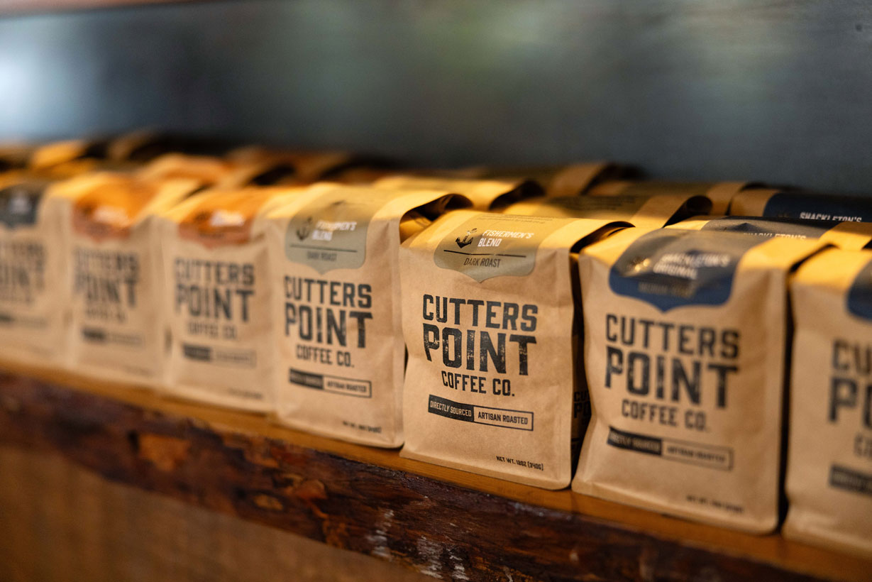 Bags of locally roasted Cutters Point Coffee neatly displayed on a café shelf, showcasing artisan quality and Pacific Northwest craft.