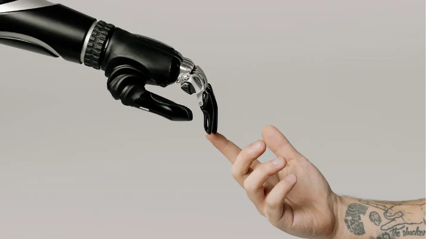 Robotic hand touching a human finger representing human and digital technology integration