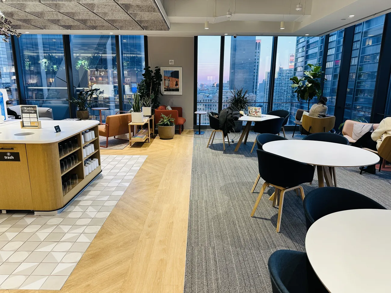 Lounge and pantry area inside the Consultadd New York office with city views