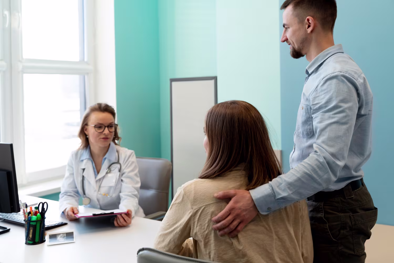 GP evaluating pregnancy with patient