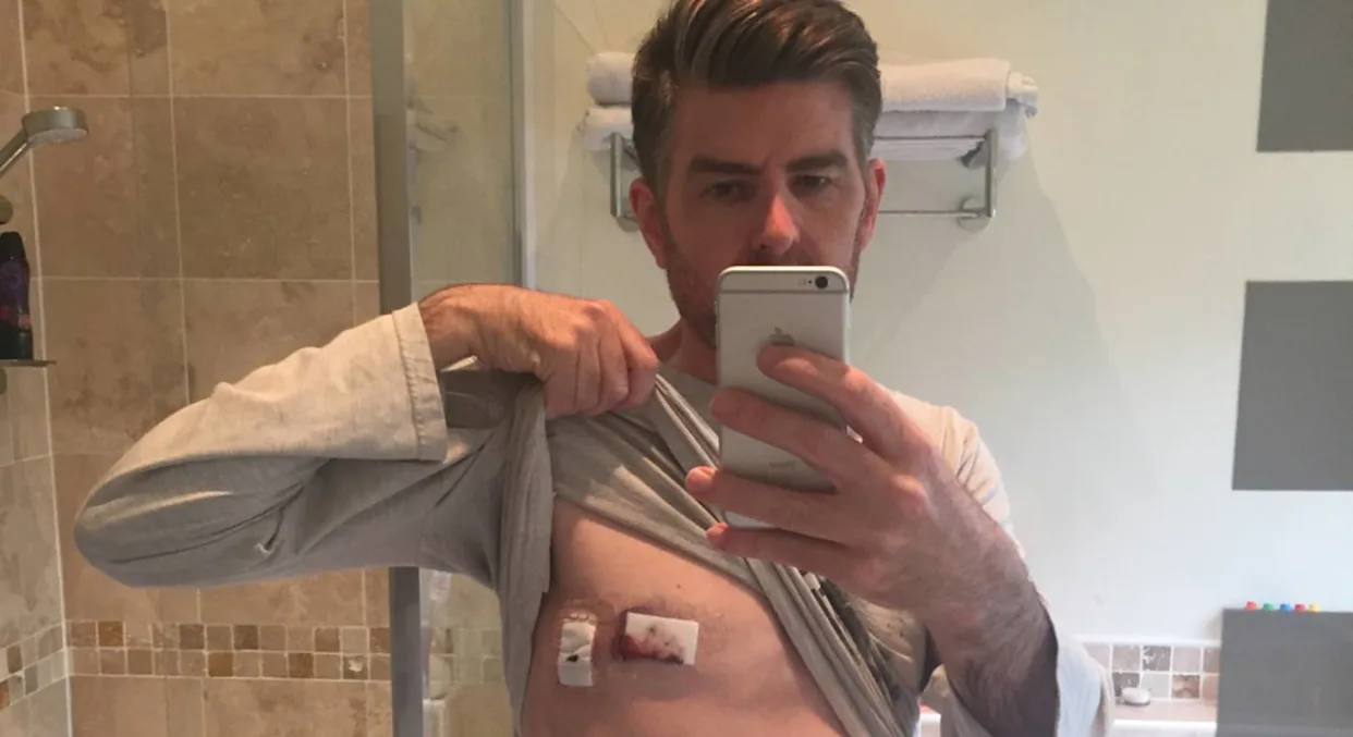 Phil Alderson standing in front of mirror and clicking his picture
