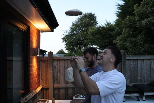 Chef placing cheese on raw pizza bread