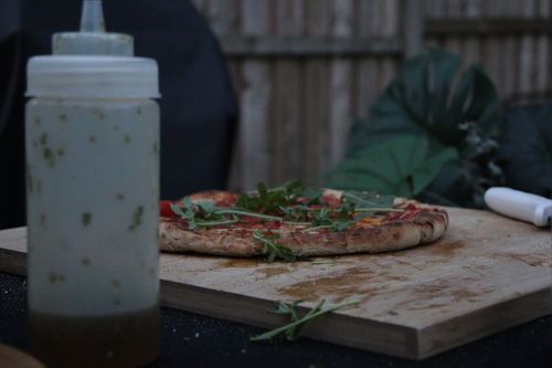 Two friends laughing and having pizza at table