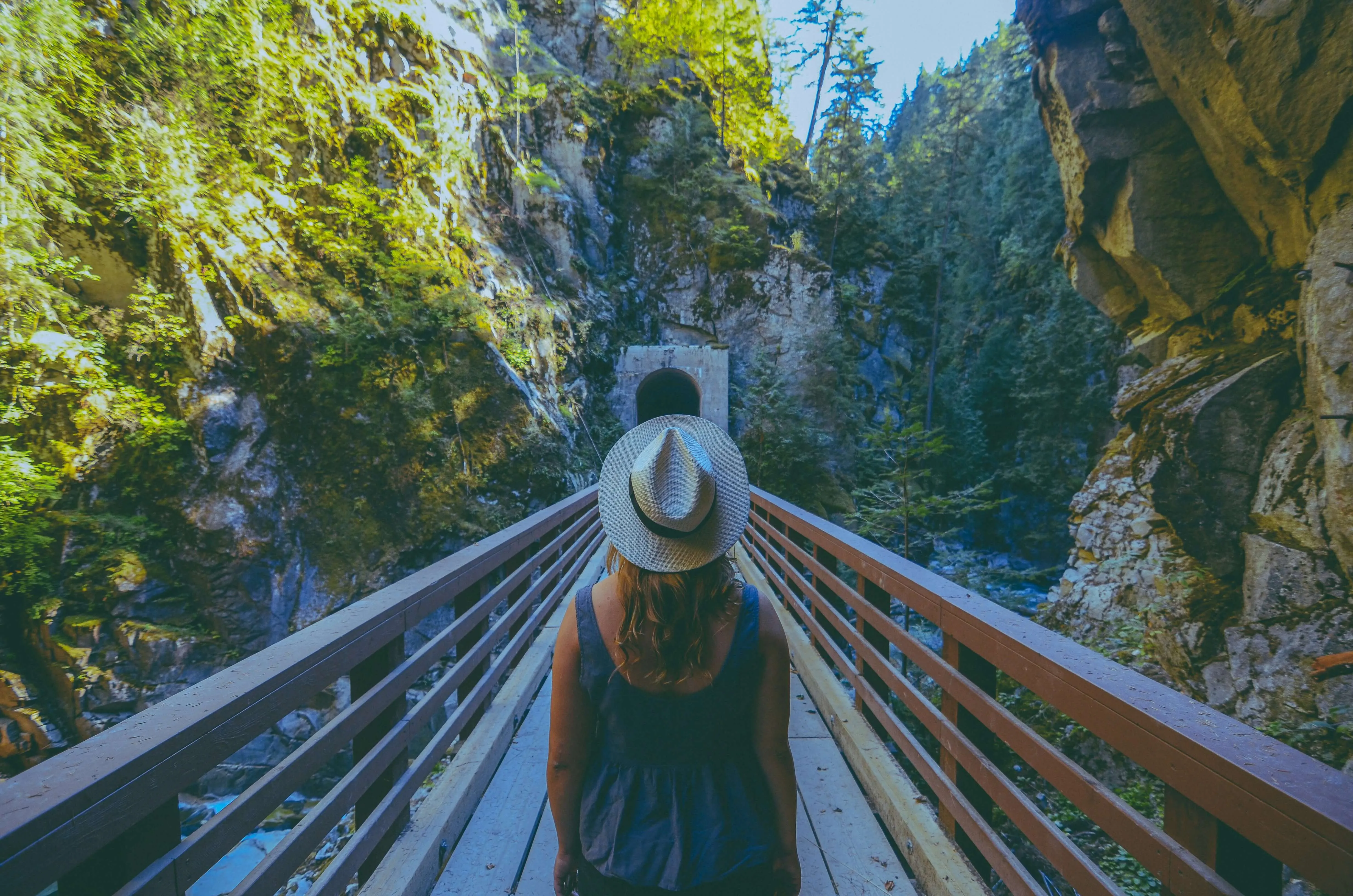 woman on the bridge looking at a tunnel