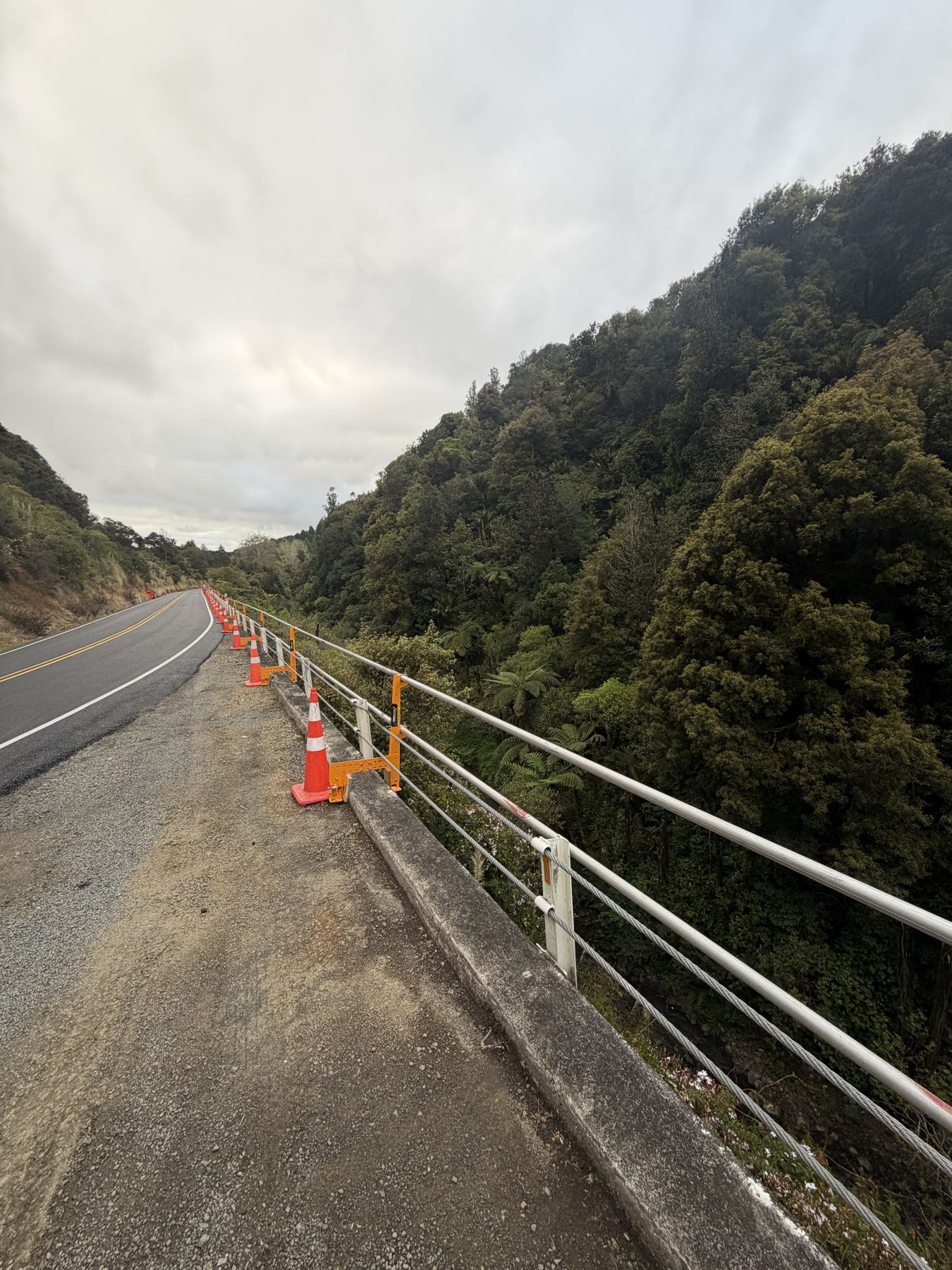 Long run of roadside edge protection following a road beside a gorge