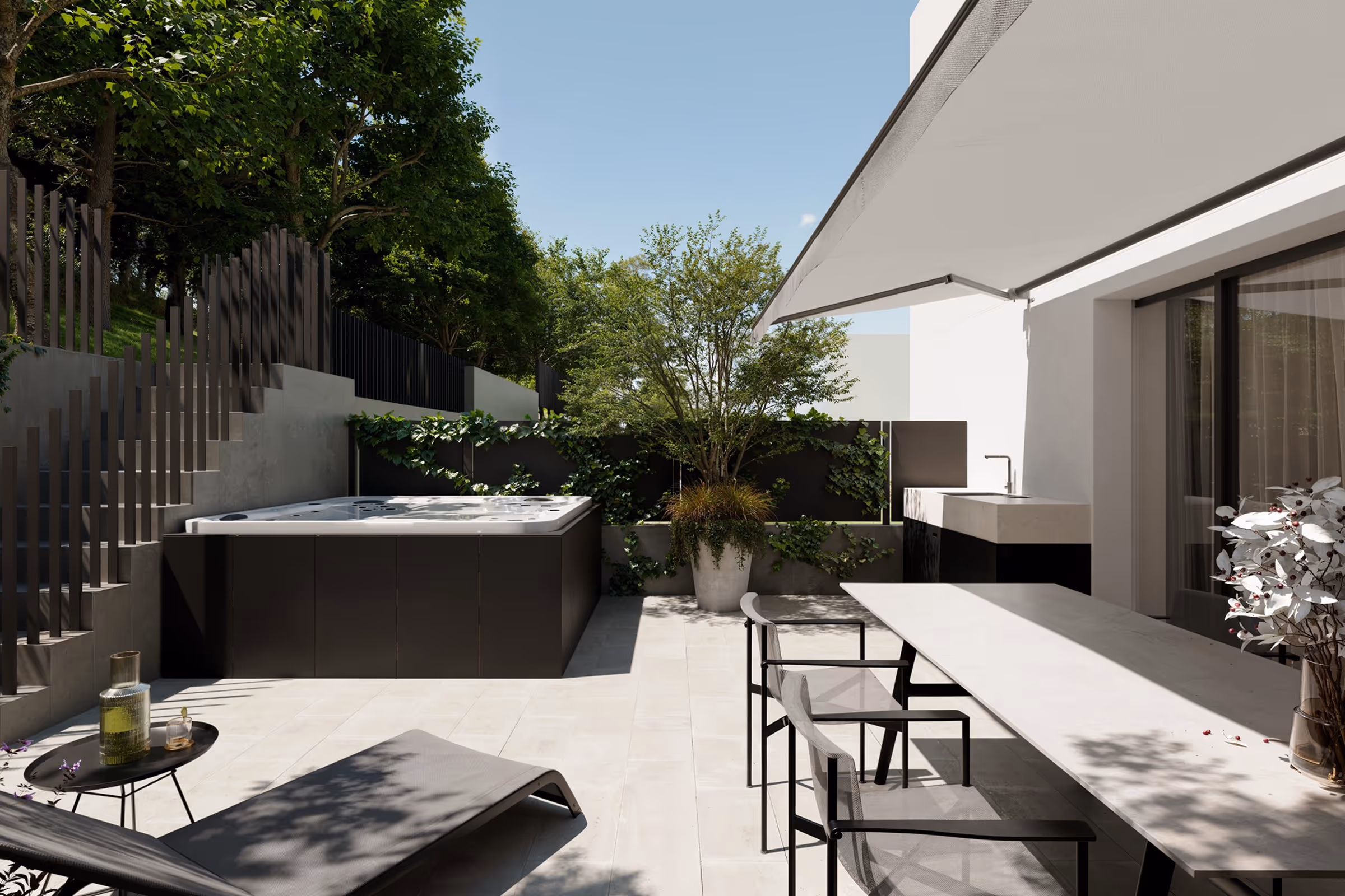 Modern outdoor patio with lounge chairs, dining table, large potted plant, built-in sink, and a jacuzzi.