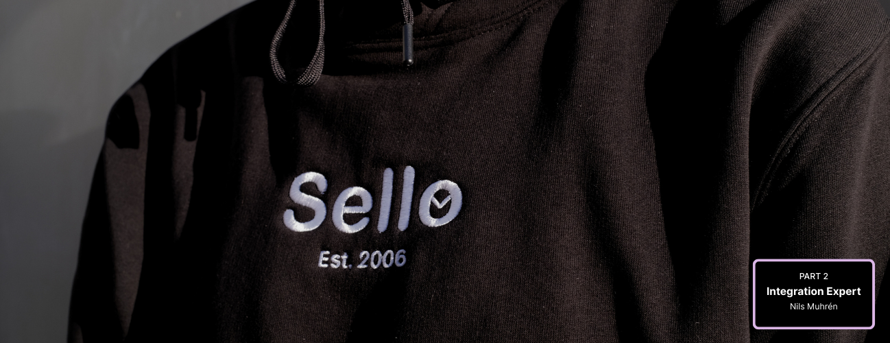Person wearing a black hoodie with a white Sello logo on the chest.
