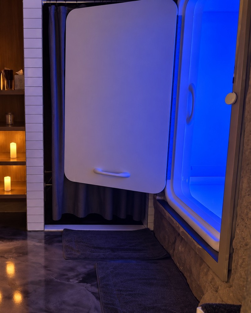 Float suite with an open float cabin lit in blue and candlelit shelves