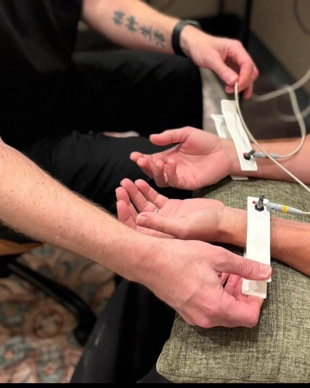 Close-up of sensors on a guest's wrists during a nervous system scan