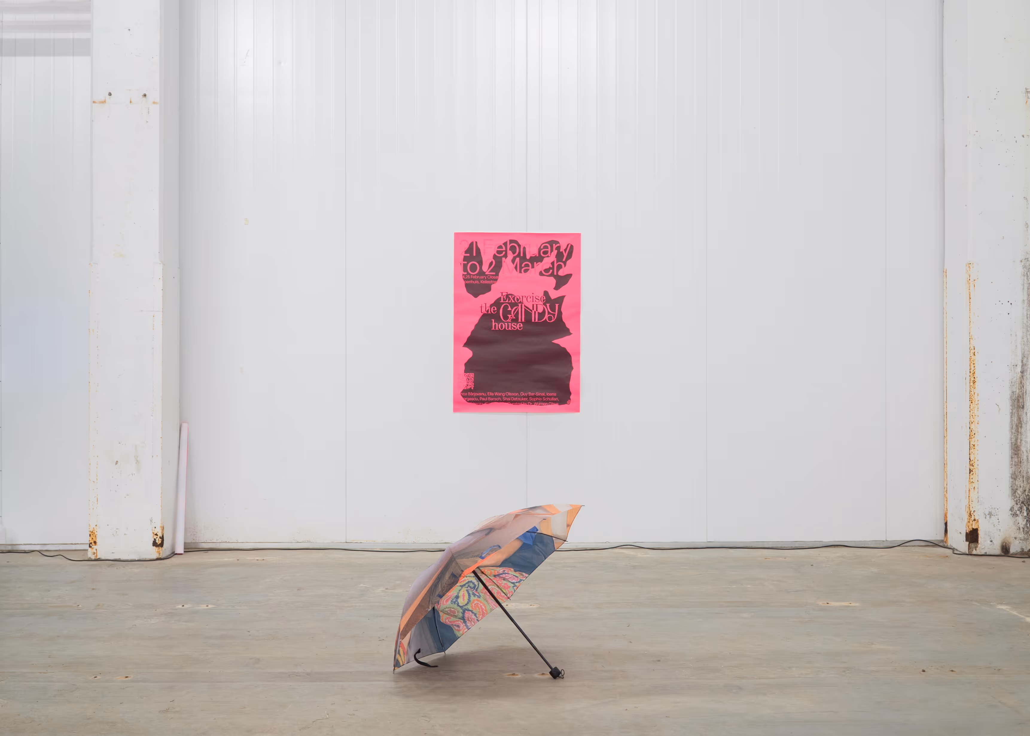 Exorcise the Candy House exhibition installation with umbrella and pink poster at Katoenhuis, Design Biennale Rotterdam 2025.