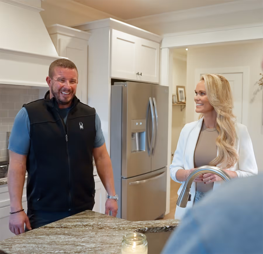 Ray Hubner standing in a modern kitchen, smiling and highlighting a positive home-buying experience.