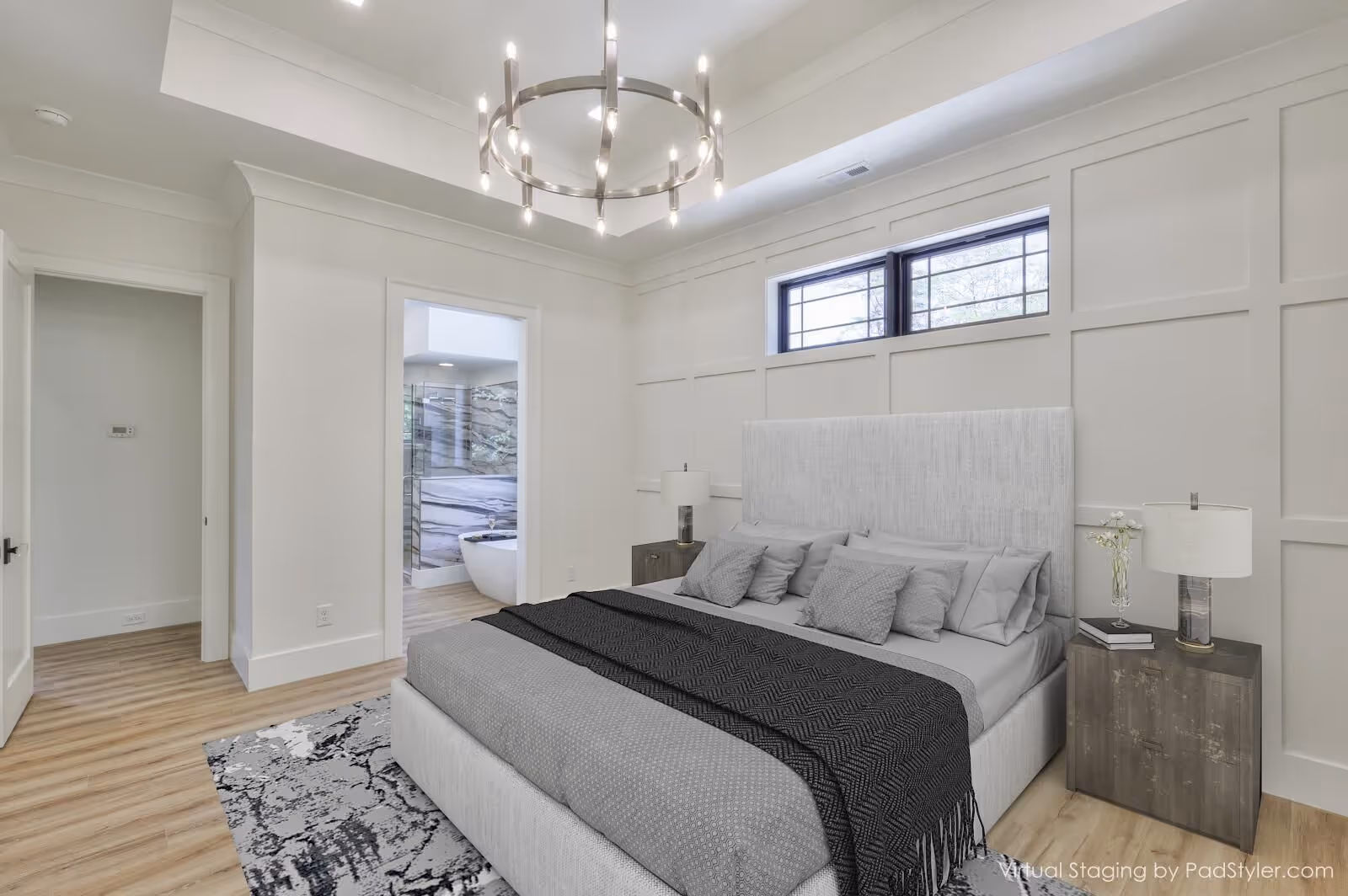 A stylishly furnished bedroom with a chandelier, neutral tones, and natural light, highlighting professional home staging for real estate marketing.