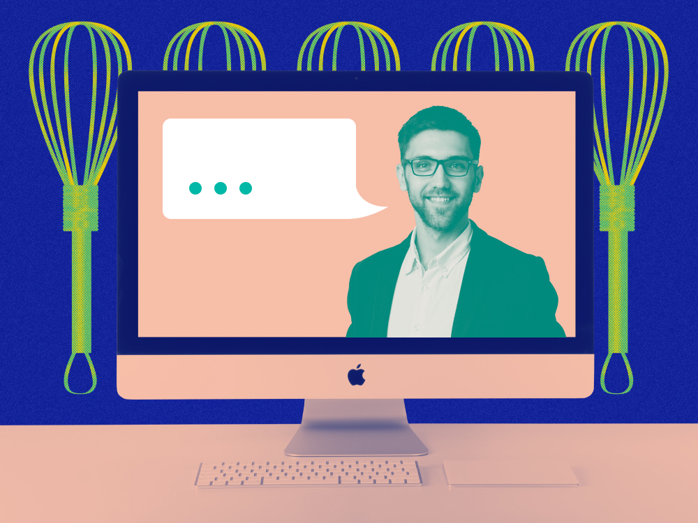 An image of a desktop computer screen with a professional in a suit speaking 