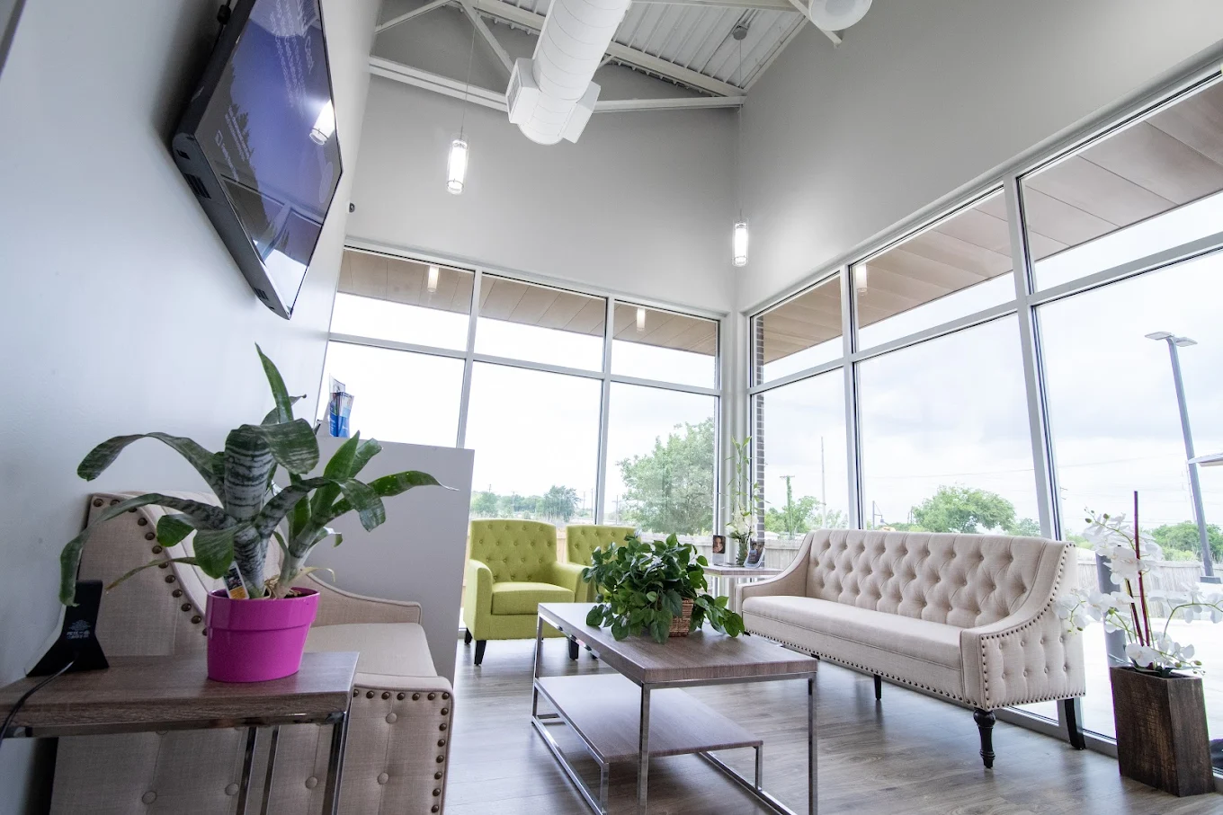 Clover Smile Studio's waiting area with plush seating, plants, and a private nook.
