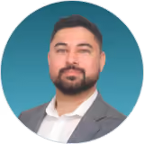 Headshot of a bearded DualEntry team member in a gray blazer